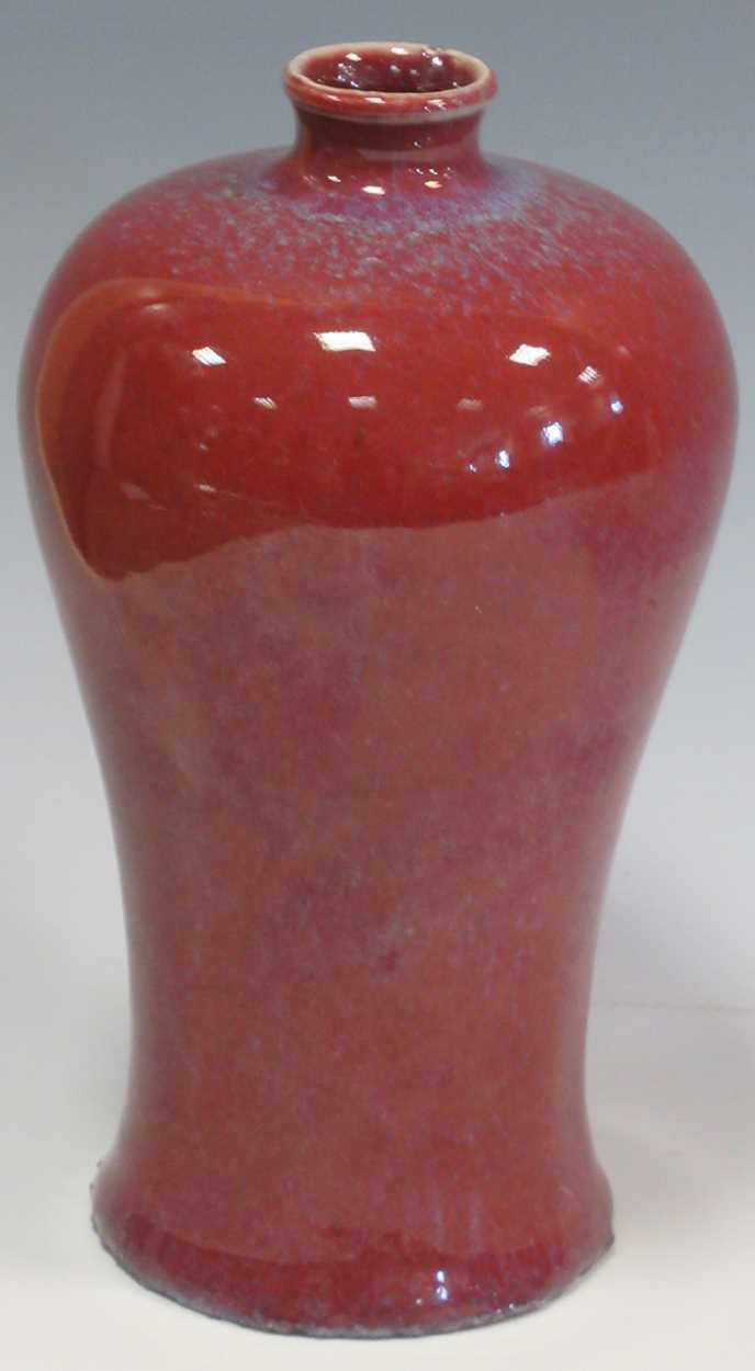 A flambe red vase with blue speckling, 19.5cm tallMiinor chip to the rim and roughness and grit to