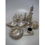 8 silver ash/pin trays together with 2 silver tea strainers and bowls, a silver sugar caster, a