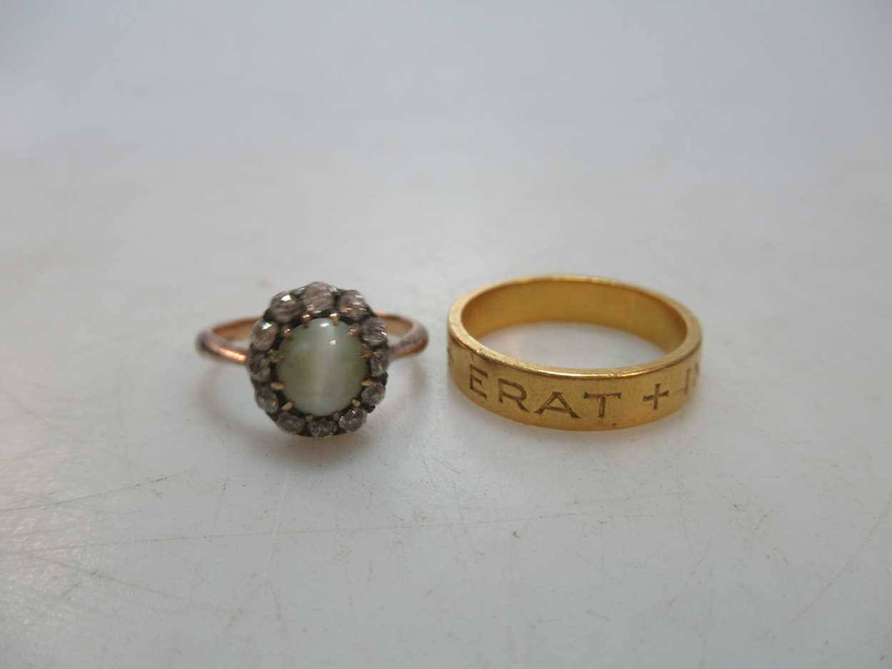 A 'cats-eye' chrysoberyl and diamond cluster ring, tested as 18ct gold, weight 2.8g, together with a