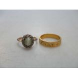 A 'cats-eye' chrysoberyl and diamond cluster ring, tested as 18ct gold, weight 2.8g, together with a