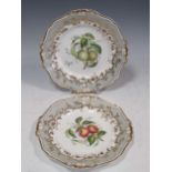 A pair of plates decorated with fruit, possibly apples and quinces, 23cm diameterGenerally,