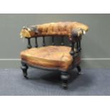 A late Victorian ebonised library armchair,