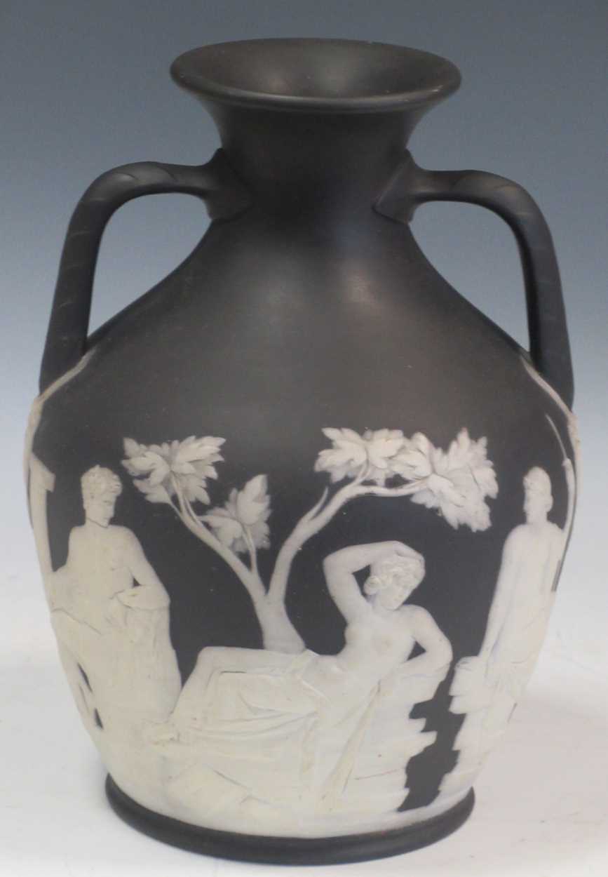 A Wedgwood black jasperware copy of the Portland vase (damage around base), 26cm high