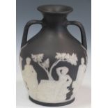 A Wedgwood black jasperware copy of the Portland vase (damage around base), 26cm high