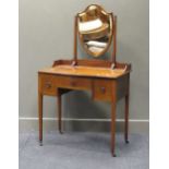 An Edwardian mahogany dressing table, the central drawer with Maple & Co label, 143 x 84 x 50cm