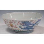 A Chinese porcelain bowl decorated with a dragon, 26cm diameterWear and surface dirt commensurate