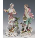 A pair of Meissen figures of a boy and girl, he wearing a puce foliate decorated jacket, green
