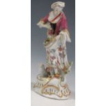 A German porcelain model of a woman with flowers, 26cm tall