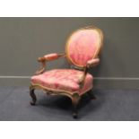 A Victorian carved frame spoonback armchair
