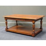 A polished mahogany coffee table with lower tier, 46 x 106.5 x 60.5cm