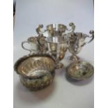 A collection of silverware including 4 trophy cups, a pair of open salts and a bowl, 38ozt gross (