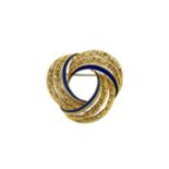 An enamel swirl brooch,