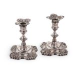 A pair of George II cast silver library candlesticks,