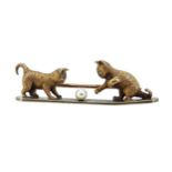 A brooch with kittens playing,