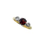 An 18ct gold garnet and diamond three stone ring,