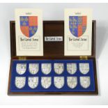 The Royal Arms, set of 12 hallmarked silver shields, issued for the 1977 Silver Jubilee, wooden