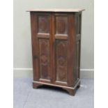 An oak cupboard in the antique style enclosed by two panelled doors, 113 x 72 x 35cm