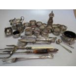 An assortment of silver, mainly napkin rings, with some flatware and cruets, 16.5ozt gross weighable