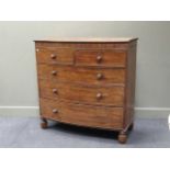 A Victorian bow fronted chest of drawers, with two short over three graduating long drawers, with