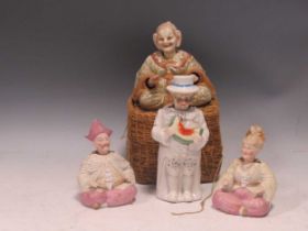 A group of four bisque nodding head figures, late 19th / early 20th century, comprising a pair of