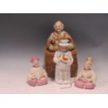 A group of four bisque nodding head figures, late 19th / early 20th century, comprising a pair of