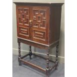 An 18th century and later oak panelled cabinet on stand, by repute from Kings College Cambridge, 140