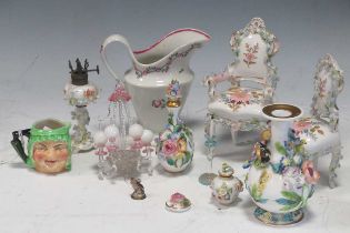 A collection of miniature Continental vases, decorated with relief flowers, together with various