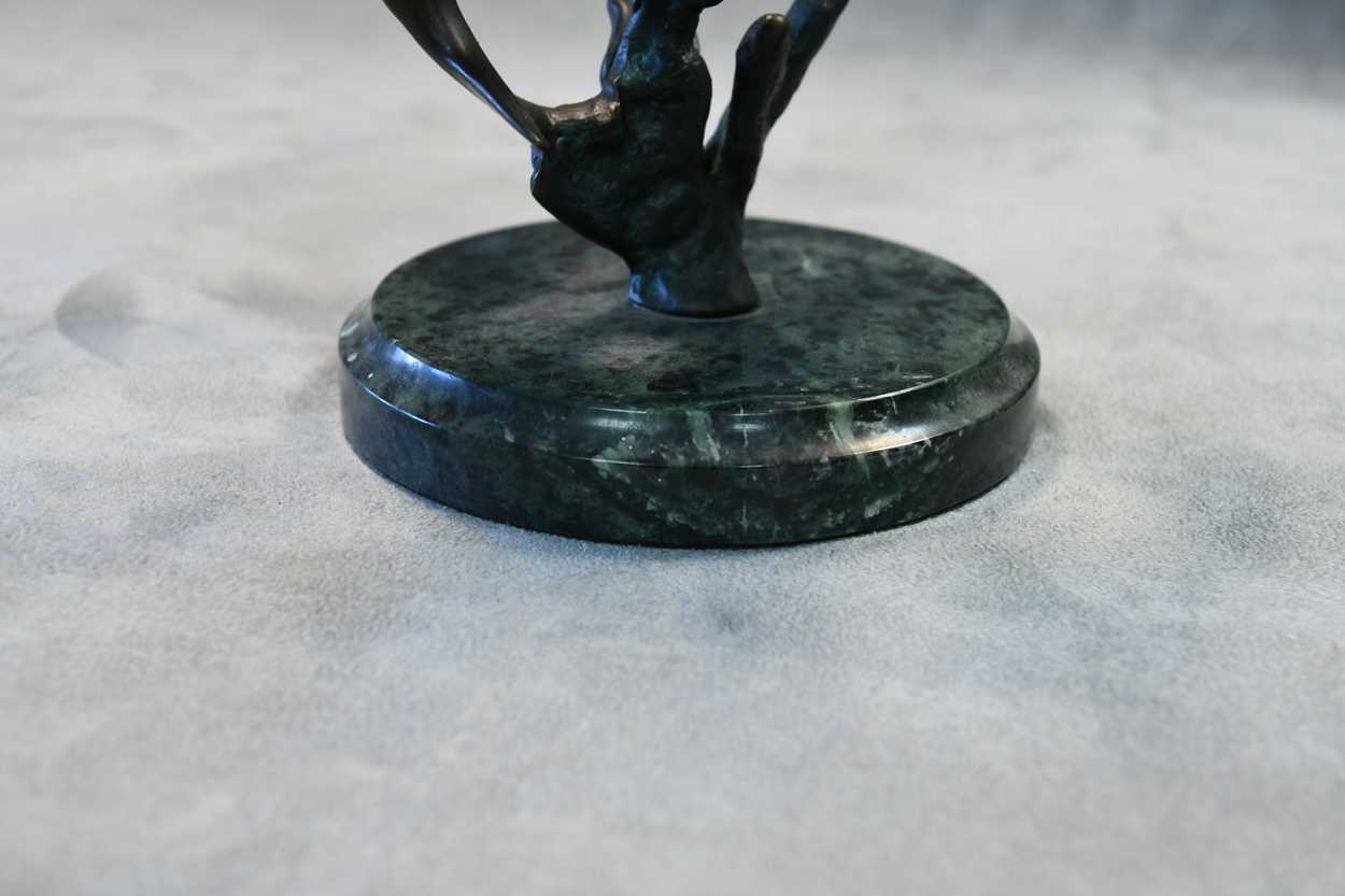 A bronze model of three swimming dolphins, the patinated model mounted to a green marble plinth - Image 4 of 8