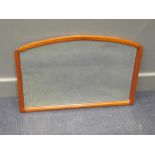 A modern wooden framed wall mirror of arched form, 47 x 70cm