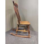 A 20th century elm seated comb back rocking chair