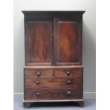 A 19th century mahogany linen press, the Greek key moulded cornice above two panelled doors