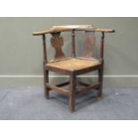 An elm seated corner chair, mid-18th century, 79 x 82 x 64cmProvenance:Wood Hall, Hilgay, Norfolk