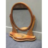 A late Victorian mahogany oval swing mirror, 69 x 57 x 24cm