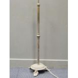 A 20th century brass standard lamp raised on stylised leaf feet, 133cm