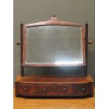 A 19th century mahogany dressing table swing mirror, the three drawer bow fronted base raised on