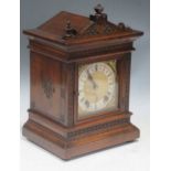 An Edwardian oak bracket clock, and a leather attached case