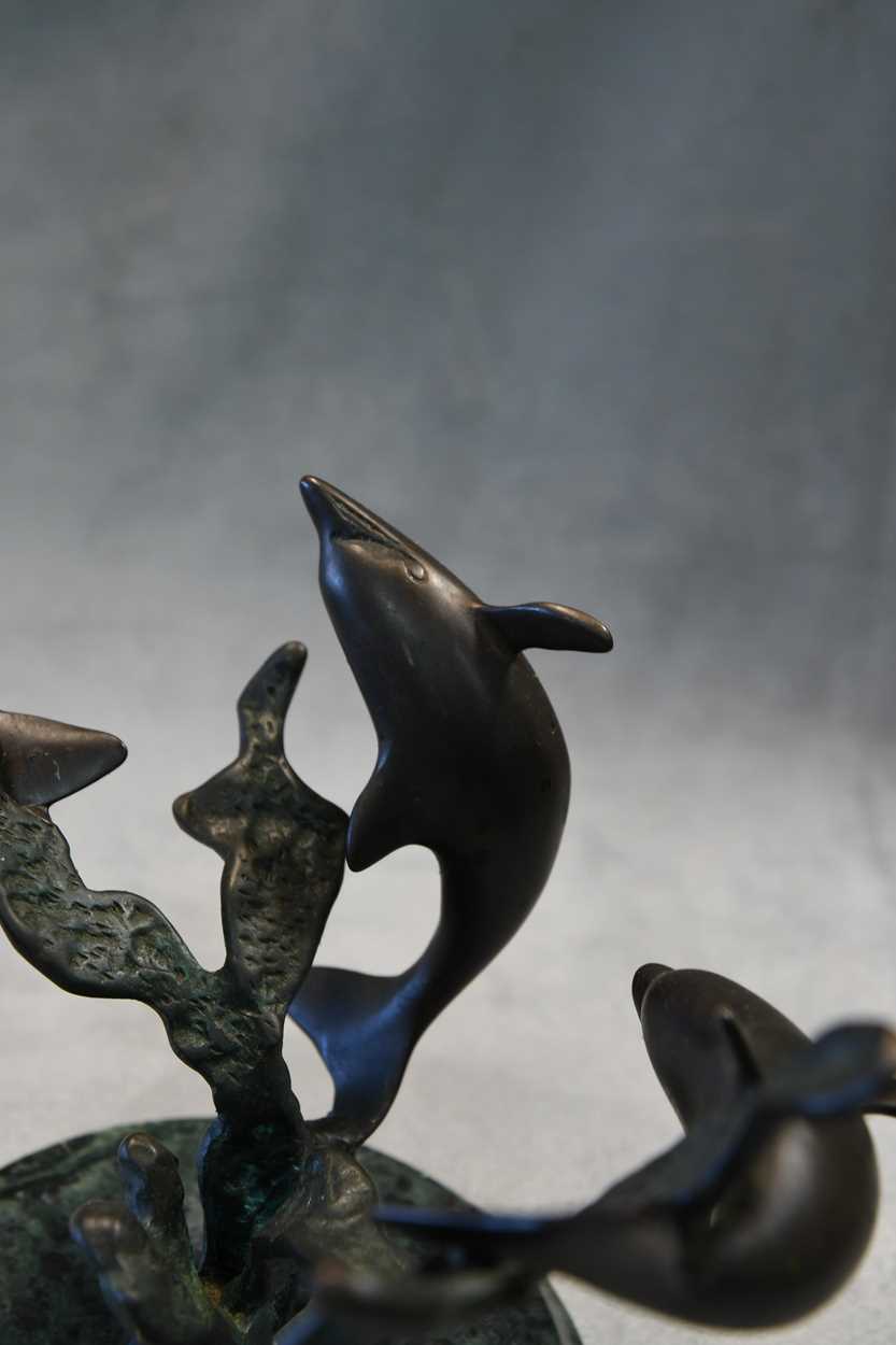 A bronze model of three swimming dolphins, the patinated model mounted to a green marble plinth - Image 3 of 8