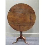 A 19th century country made oak tilt-top tripod table, 71cm high 79cm diameter