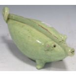 A green glazed pottery 'pig' form money box, probably Continental 19th century, 18.5cm wide; and a