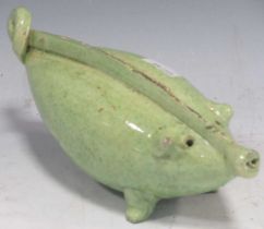 A green glazed pottery 'pig' form money box, probably Continental 19th century, 18.5cm wide; and a