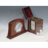 A French carriage clock together with another 8 day repeating mid century mantle clock