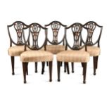 A set of five George III Hepplewhite style mahogany dining chairs, the shield-shaped backs with