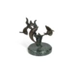 A bronze model of three swimming dolphins, the patinated model mounted to a green marble plinth