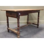 An 18th century fruitwood? kitchen table, a three plank top with single end drawer on turned legs