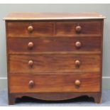 A 19th century mahogany chest of two short over three long drawers with turned knob handles raised