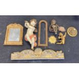 A painted wooden model of a cherub, 56cm long, an Italian style mirror, 42 x 33cm, a carved giltwood