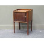 A George III tambour fronted mahogany night table, the tray over top over a single cupboard door,