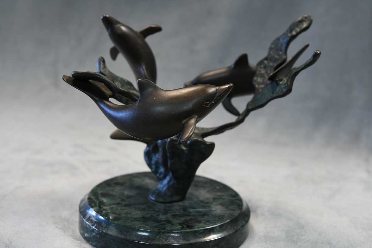 A bronze model of three swimming dolphins, the patinated model mounted to a green marble plinth - Image 2 of 8