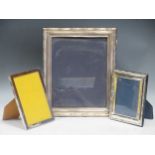 A group of three modern silver photo frames, one marked for Birmingham 1996, 30cm high; another