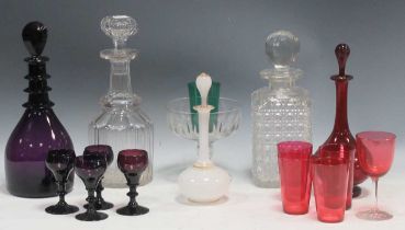 A collection of glassware to include, a cut glass decanter, a purple decanter together with four